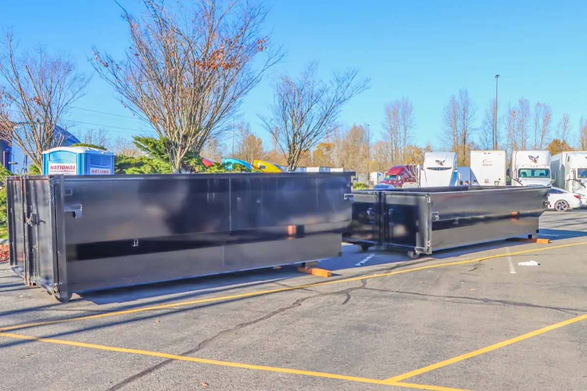 Professional dumpster rental service with roll-off container on residential driveway in Lakehills